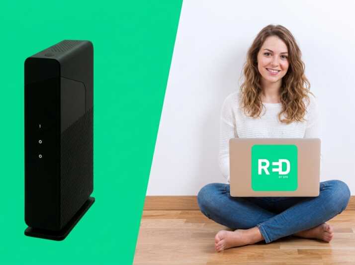 Une jeune femme européenne assise avec un ordinateur portable portant le logo RED by SFR à côté d'une box internet.