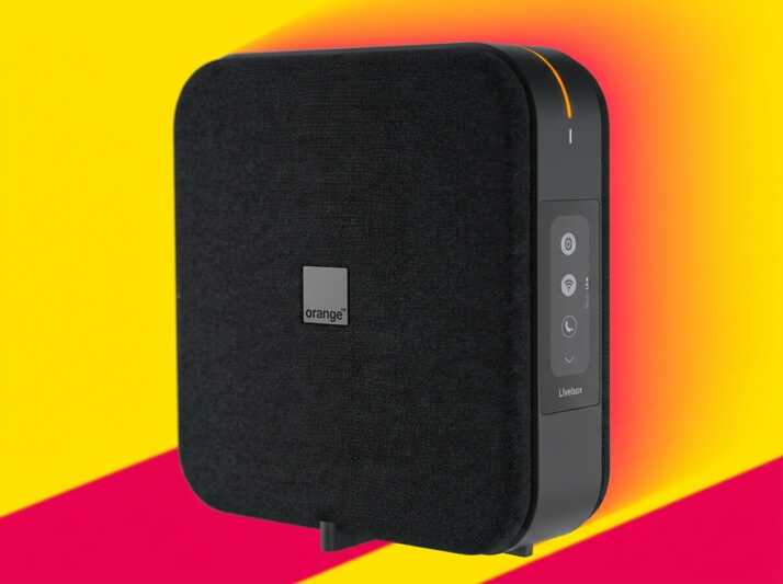 Modem Livebox Orange noir sur fond jaune et rose.